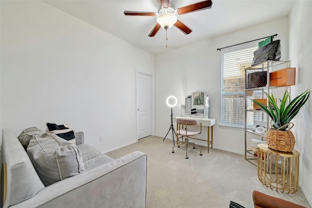 office space featuring plenty of natural light, ceiling fan, and light colored carpet