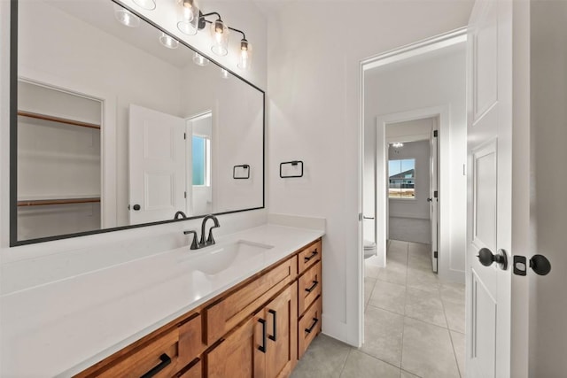 bathroom featuring tile patterned flooring, vanity, and toilet