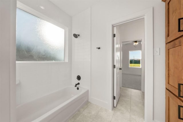 bathroom featuring tile patterned flooring, tiled shower / bath combo, and ceiling fan