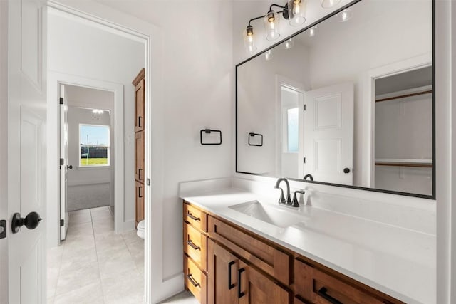 bathroom featuring tile patterned floors, vanity, and toilet