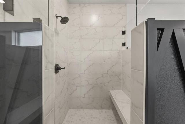 bathroom with a tile shower