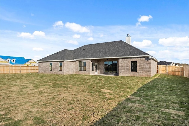 back of house featuring a lawn