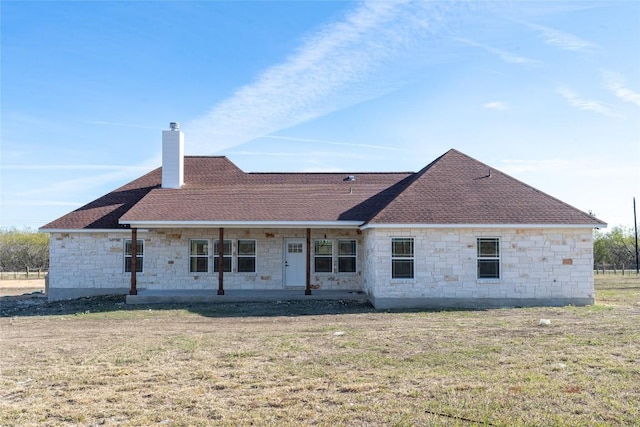 back of house featuring a lawn