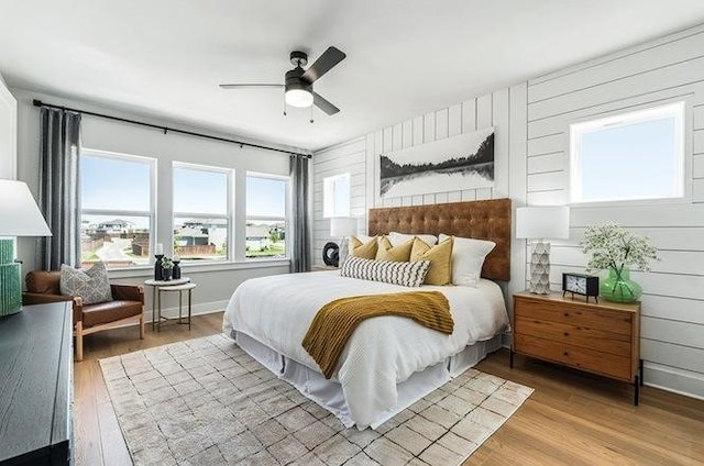 bedroom with ceiling fan and light wood-type flooring