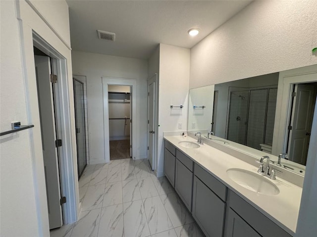 bathroom with an enclosed shower and vanity