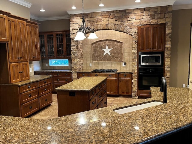 kitchen featuring stainless steel appliances, a notable chandelier, backsplash, pendant lighting, and a kitchen island