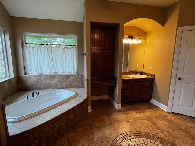 bathroom with vanity, tiled bath, and tile patterned floors