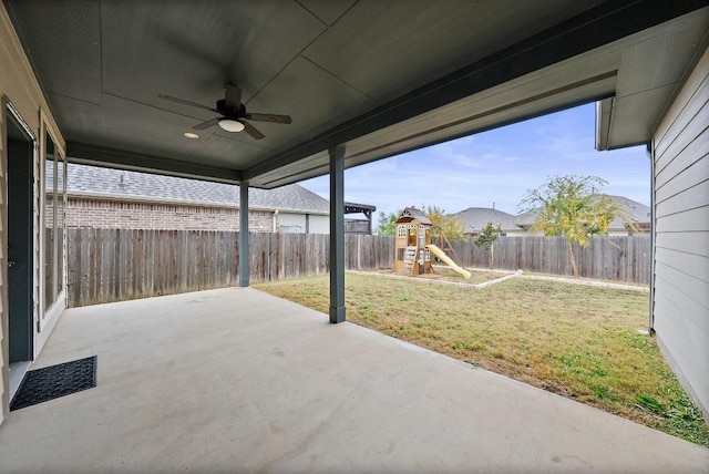 view of patio with a playground and ceiling fan