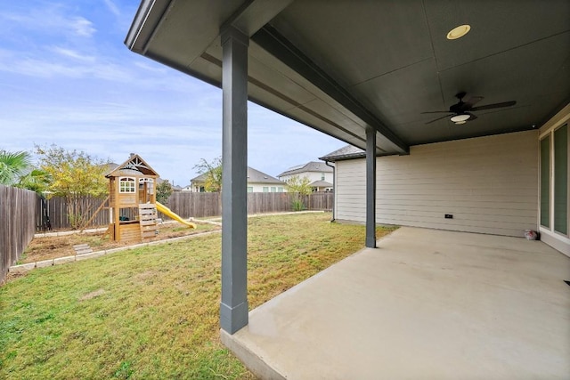 view of yard with a playground and ceiling fan