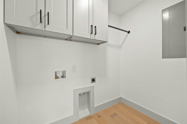 washroom featuring hardwood / wood-style floors, cabinets, hookup for a washing machine, hookup for an electric dryer, and electric panel