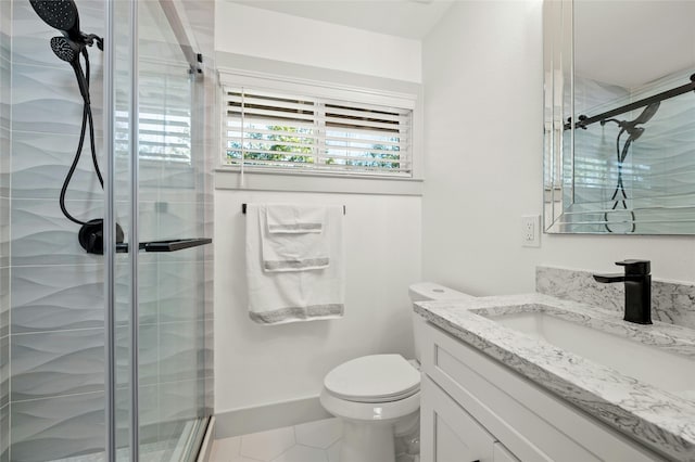 bathroom featuring a shower with door, toilet, and vanity