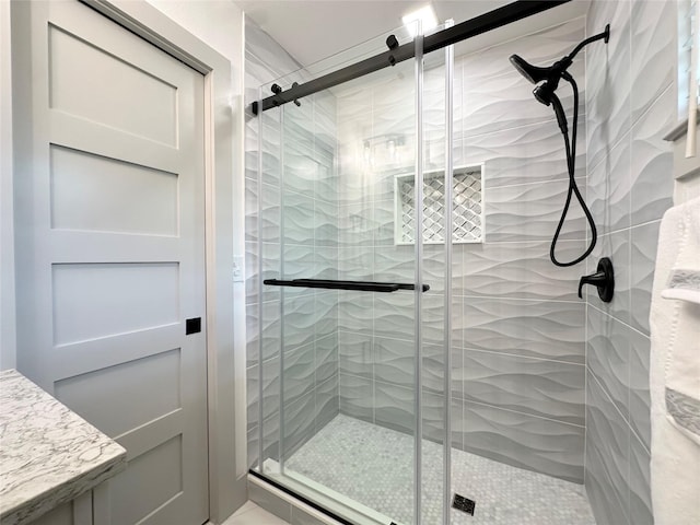 bathroom featuring a shower with shower door