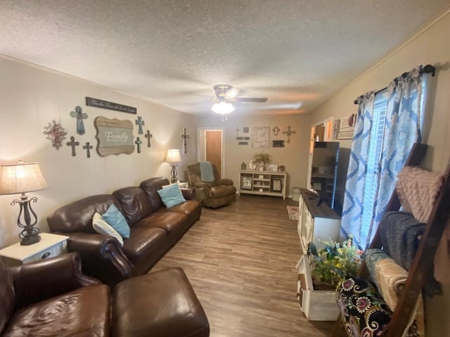 living room with hardwood / wood-style floors, ceiling fan, and a textured ceiling