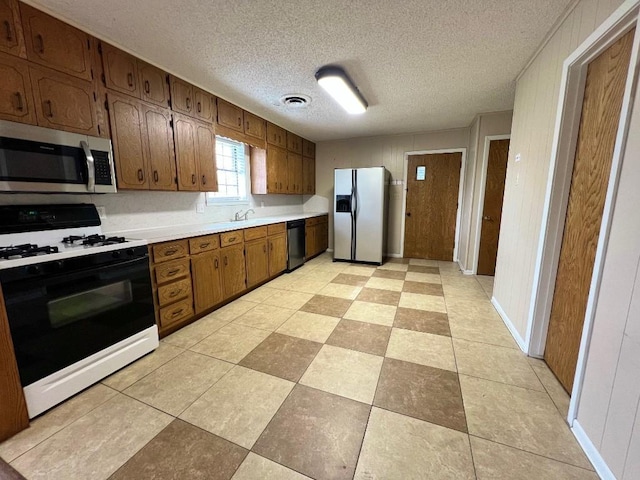 kitchen featuring a textured ceiling and stainless steel appliances