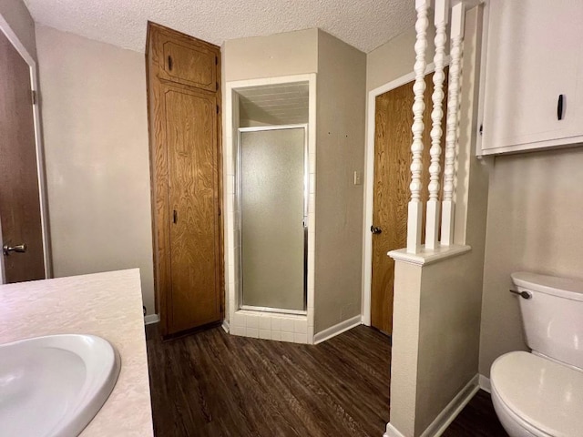 bathroom with hardwood / wood-style flooring, sink, a shower with shower door, and a textured ceiling