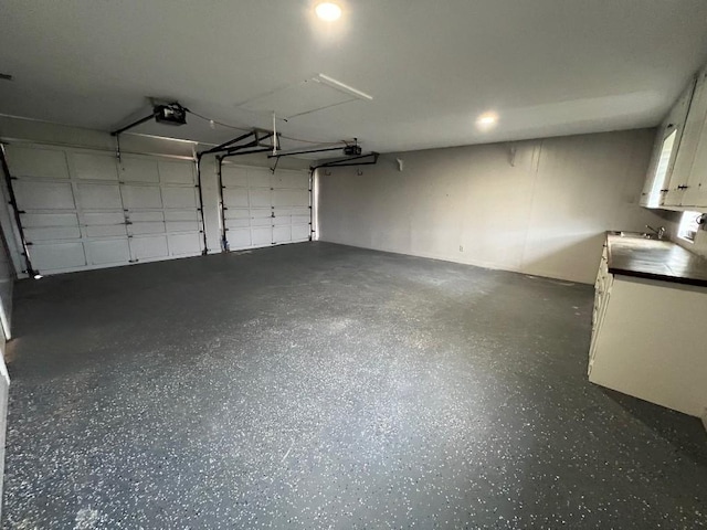 garage with sink and a garage door opener