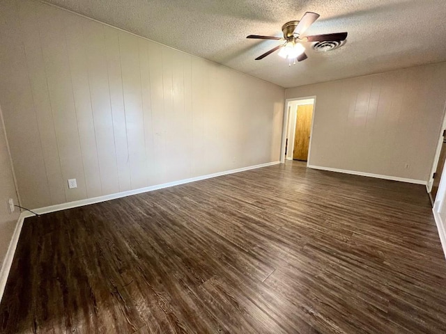 spare room featuring a textured ceiling, dark hardwood / wood-style flooring, and ceiling fan