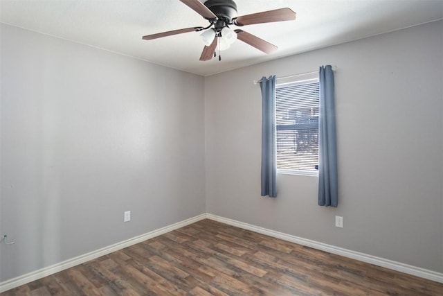 spare room featuring dark wood finished floors, baseboards, and ceiling fan