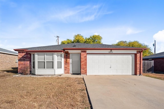single story home featuring brick siding, an attached garage, driveway, and a front lawn