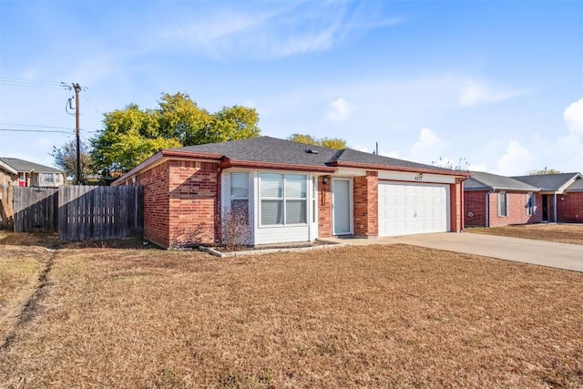 ranch-style home featuring a front lawn, driveway, fence, a garage, and brick siding