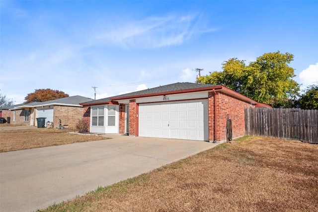 single story home featuring an attached garage, fence, brick siding, and concrete driveway