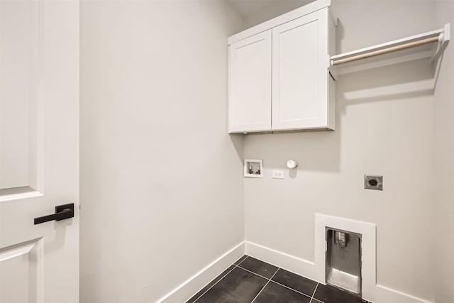 laundry room featuring cabinets, electric dryer hookup, hookup for a gas dryer, dark tile patterned floors, and hookup for a washing machine