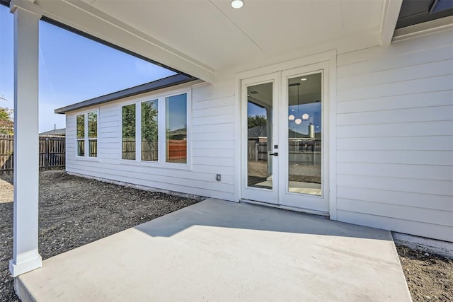 view of exterior entry featuring a patio and french doors