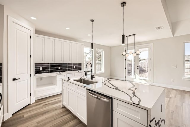 kitchen featuring white cabinetry, sink, a healthy amount of sunlight, and stainless steel dishwasher