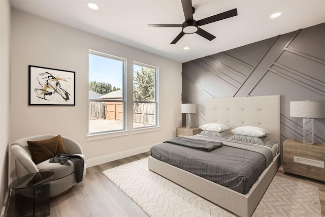 bedroom with light hardwood / wood-style floors and ceiling fan