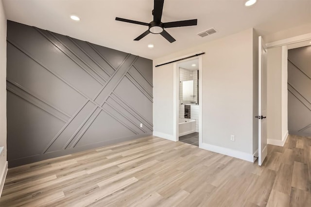 spare room featuring light hardwood / wood-style flooring and ceiling fan