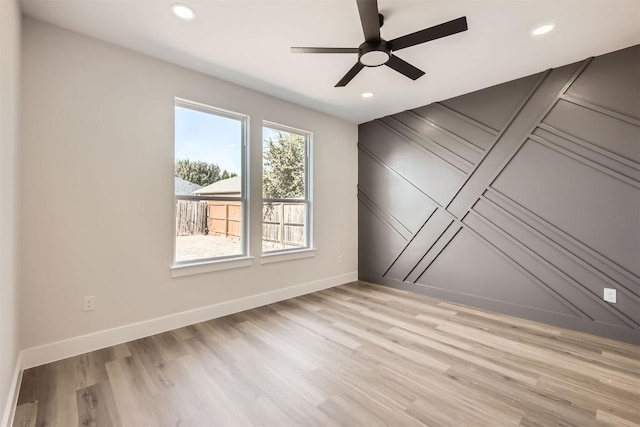 unfurnished room with ceiling fan and light hardwood / wood-style flooring