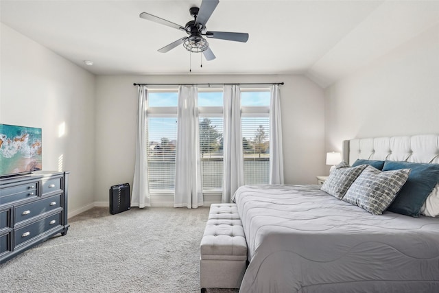 bedroom with ceiling fan, light carpet, and vaulted ceiling