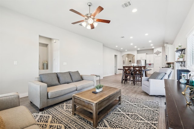 living room featuring ceiling fan and light wood-type flooring