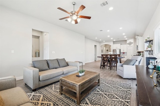 120 Krupp Ave, Liberty Hill, TX 78642 - living area featuring arched walkways, ceiling fan, light wood-style flooring, baseboards, and recessed lighting