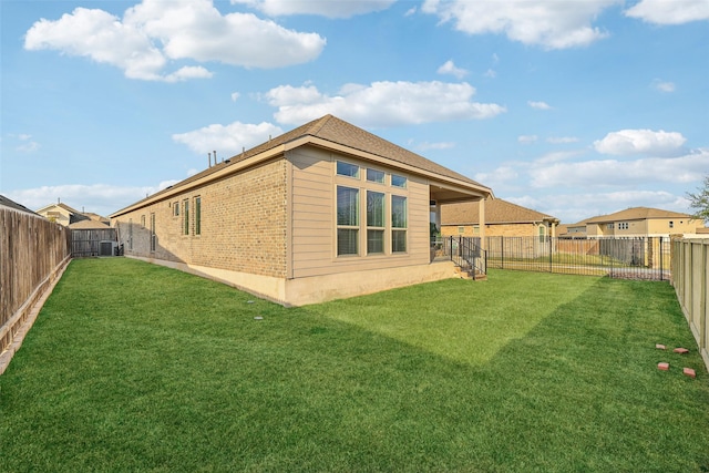 view of property exterior with a yard and central AC