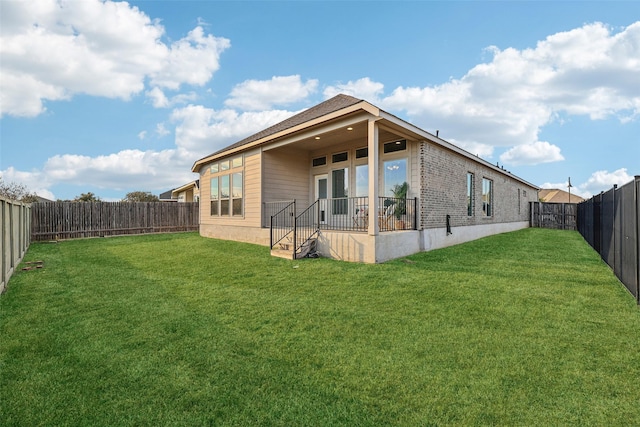 back of house with a lawn