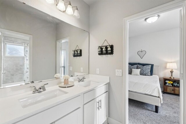 120 Krupp Ave, Liberty Hill, TX 78642 - ensuite bathroom with double vanity and baseboards