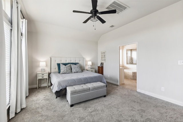 carpeted bedroom with ceiling fan, lofted ceiling, and connected bathroom