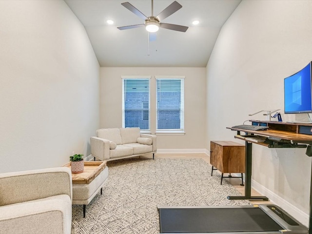 living area featuring ceiling fan and vaulted ceiling