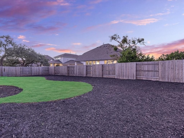 view of yard at dusk