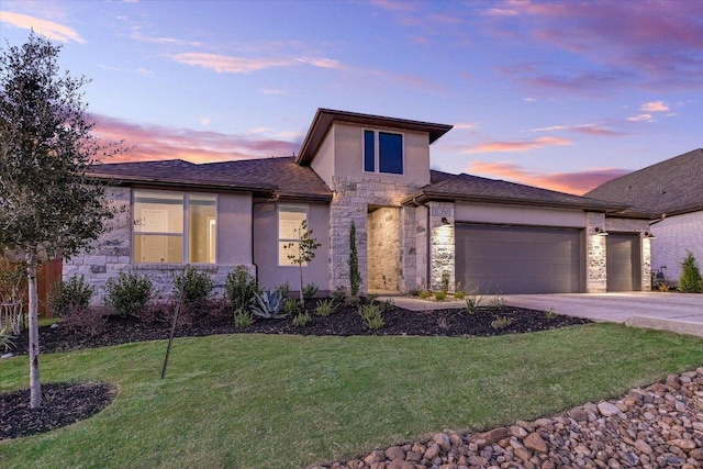 view of front of house with stone siding, an attached garage, driveway, and stucco siding