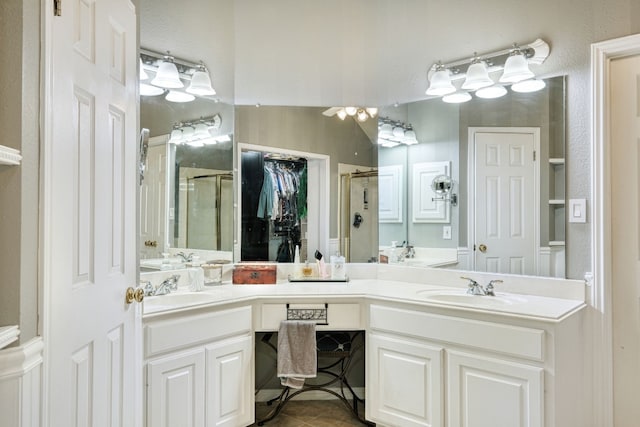 bathroom featuring tile patterned flooring, vanity, and an enclosed shower