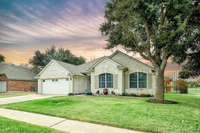 view of front of house featuring a lawn and a garage