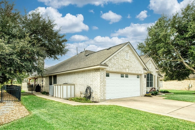 view of home's exterior featuring a lawn and a garage