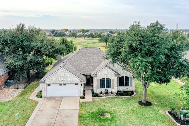 view of front of home featuring a garage and a front lawn