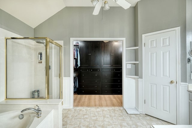 bathroom with plus walk in shower, vaulted ceiling, and ceiling fan