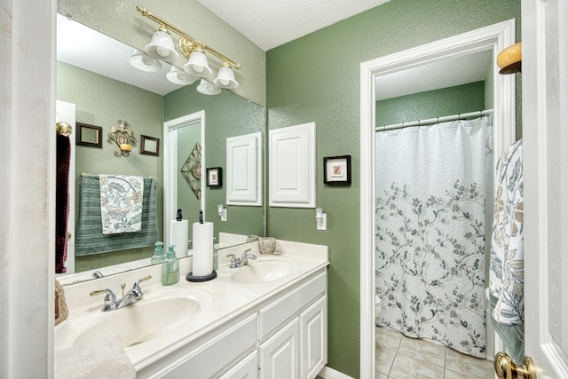 bathroom featuring tile patterned flooring, a shower with curtain, vanity, and a textured ceiling