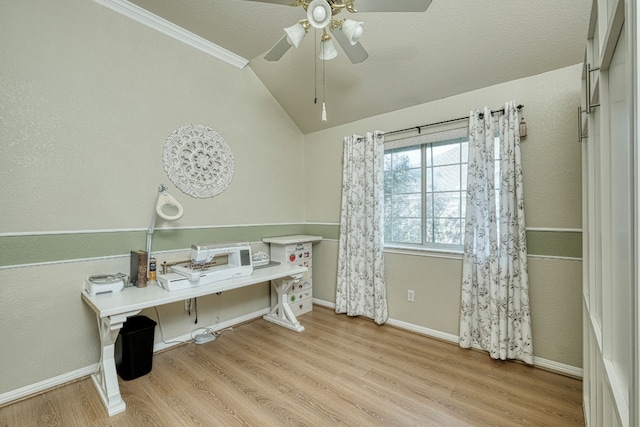 office with ornamental molding, a textured ceiling, vaulted ceiling, ceiling fan, and light hardwood / wood-style floors