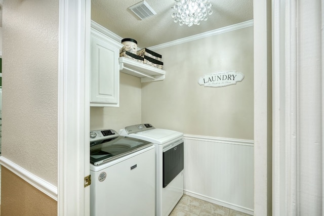 laundry room featuring cabinets, a textured ceiling, crown molding, separate washer and dryer, and an inviting chandelier