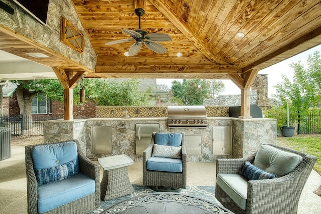 view of patio / terrace featuring a gazebo, a grill, ceiling fan, and exterior kitchen